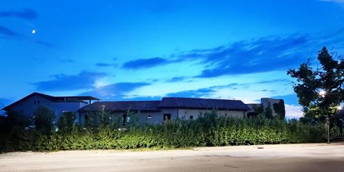 an old building sitting in a field of tall grass at Murrae Loft in La Morra