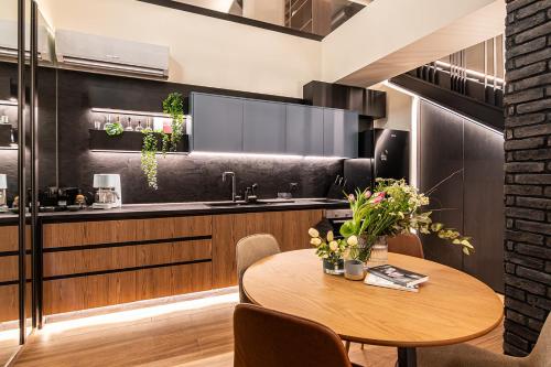 a kitchen with a wooden table and a sink at MoonLight Lofts APHRODITE & POSEIDON in Alexandroupoli