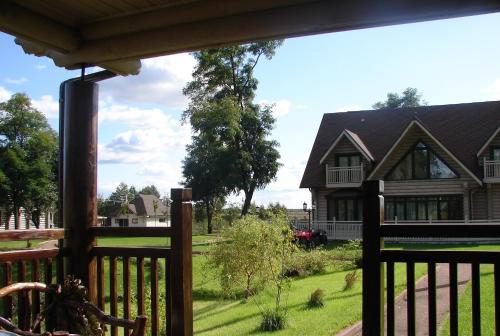 a view of a house from a porch at Pastoral wooden hauses in Velikiy Les
