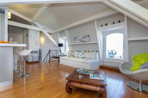 a living room with a couch and a table at ETATS UNIS 896 - Magic view wrooftop terrace in Nice