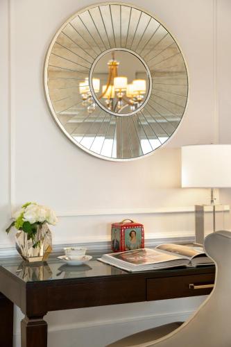 a desk with a mirror on a wall at Fairmont Le Chateau Frontenac in Quebec City