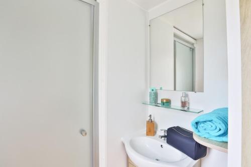a bathroom with a sink and a mirror at Camping maeva Club L'Atlantique in Angles