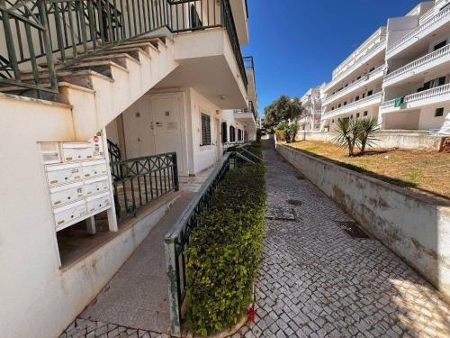 an empty street in front of a building at T1 with pool access concessiao Cabanas Tavira in Tavira