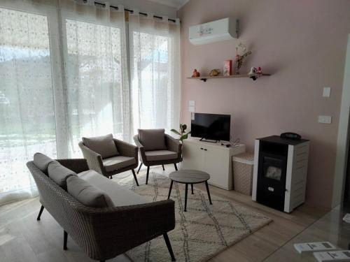 a living room with a couch and chairs and a tv at Tra Toscana e Umbria in Monterchi
