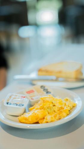 a plate of food with eggs and butter on a table at Howard Johnson Neuquen in Neuquén