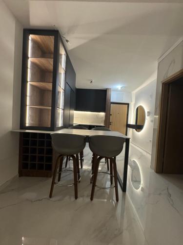 a kitchen with a table and chairs in a room at Royal Apartments in Skopje