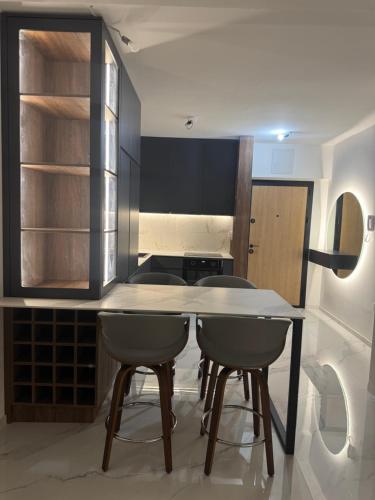 a kitchen with a table and two chairs at Royal Apartments in Skopje