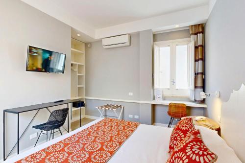 a hotel room with a bed and a balcony at Aegusa Hotel in Favignana