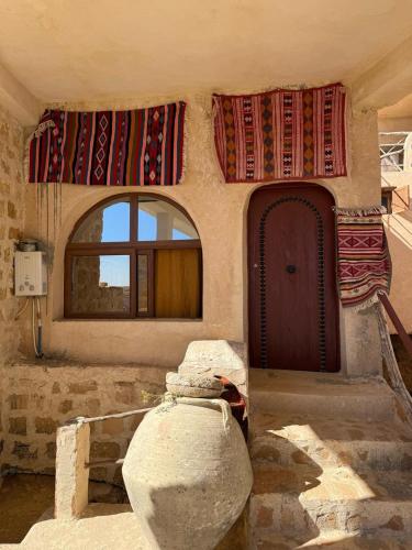 a room with a building with a door and a window at Dar Fatma Toujane in Tūjān