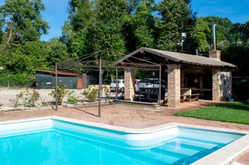 a pavilion and a swimming pool in a yard at appartamentino Villa Elena in Grutti
