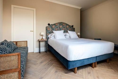 a bedroom with a large bed and a couch at Hotel Boutique Làpety in Tarragona