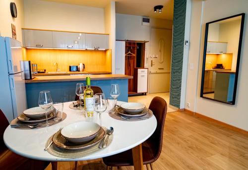 a white table with plates and glasses on it in a kitchen at Feel Home CENTRAL SUPERIOR # AC # Elevator in Budapest