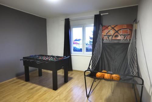 a room with a ping pong table in a room at SPA Villa ALEMI, Private Pool, Sauna & Free Parking in Brodarica