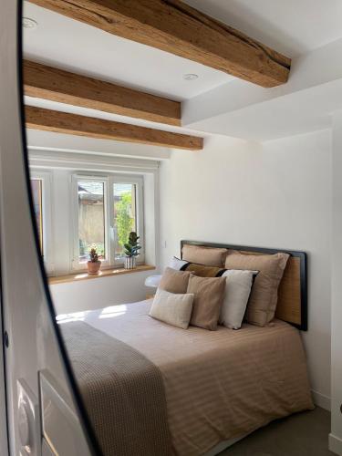 une chambre avec un lit dans une pièce avec des plafonds en bois dans l'établissement Exceptional location between lake and pedestrian street, à Annecy