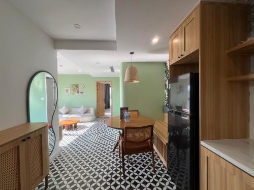a kitchen with a table and a living room at Gold Coast Apartment Seaview in Nha Trang