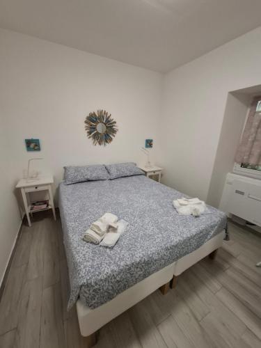 a bedroom with a bed with two towels on it at Casa Emma in Chiavari