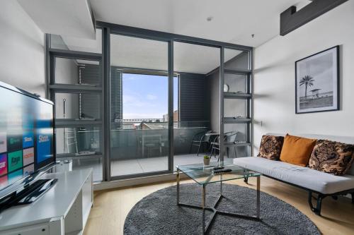 a living room with a couch and a glass table at 58A 2Storey Abnb-Style Apt with 2BR Plus Parking, Walk to Ashfield Mall and Train in Sydney