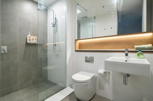 a bathroom with a toilet and a sink and a shower at 58A 2Storey Abnb-Style Apt with 2BR Plus Parking, Walk to Ashfield Mall and Train in Sydney