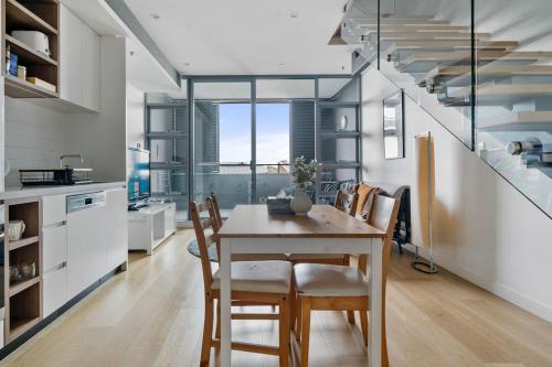 a kitchen and dining room with a table and chairs at 58A 2Storey Abnb-Style Apt with 2BR Plus Parking, Walk to Ashfield Mall and Train in Sydney