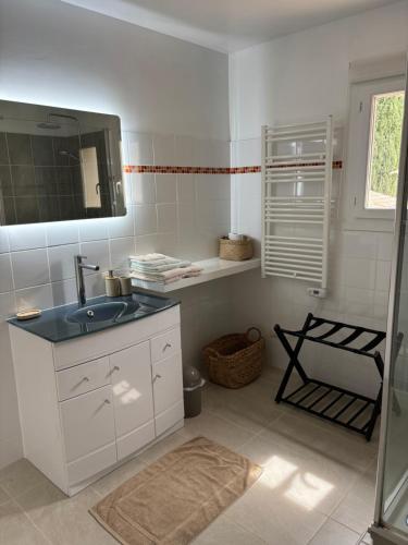 a white bathroom with a sink and a mirror at Villa Bonheur Vallespir in Céret