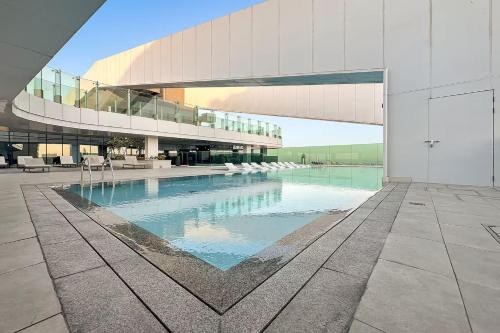 a large building with a swimming pool in front of it at Dubai Frame Views Steps from Metro & Sheikh Zayed Road in Dubai