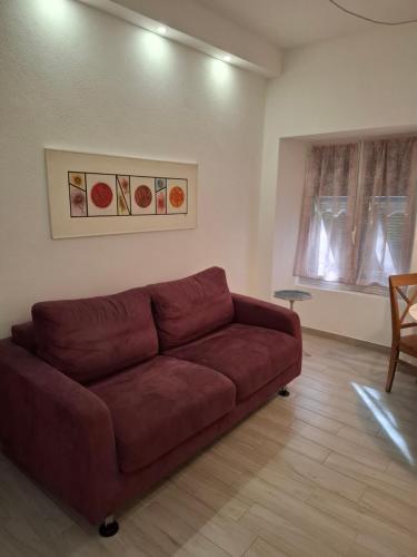 a living room with a brown couch in a room at Casa Emma in Chiavari