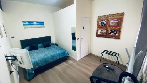 a bedroom with a bed and a table and a mirror at Nel Cuore di Faenza in Faenza