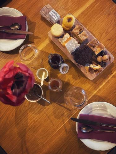 a table topped with a tray of pastries and wine glasses at Agriturismo Tenuta San Giuseppe in Cossano Belbo