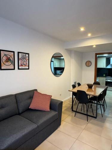a living room with a couch and a table at Cala Paula in Lloret de Mar