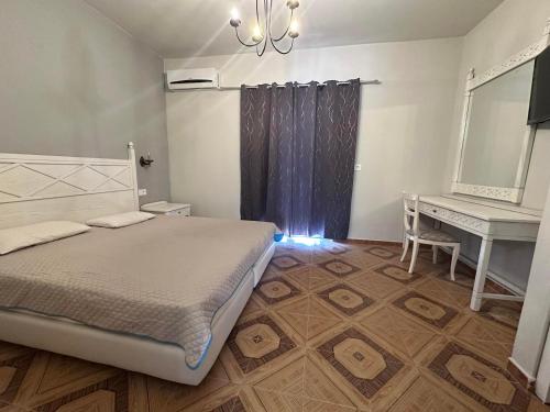 a bedroom with a bed and a desk and a mirror at Dionysia Studios in Kefalos