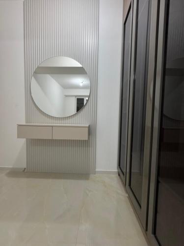 a bathroom with a mirror on a wall with a counter at Royal Apartments in Skopje