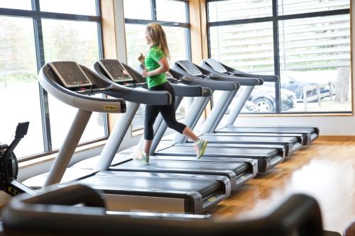 a woman walking on a treadmill in a gym at Ljungsbro Vandrarhem in Ljungsbro