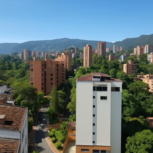 a white building in the middle of a city at Mio Loft - Vista El Poblado Free Parking Recepción 24h High Internet in Medellín