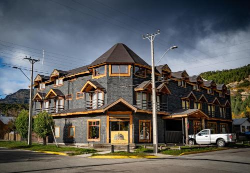 a large building on the side of a street at Apart Hotel y Cabañas Valle Exploradores in Puerto Tranquilo