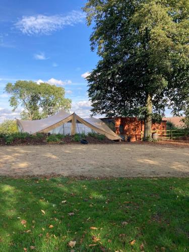 a tent is set up next to a tree at Charming 18th Century property in Topcliffe Station