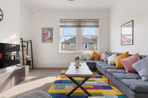 a living room with a couch and a coffee table at The Turnpike Residence - Free Parking in London