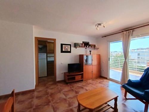 a living room with a couch and a table at Ayf luminoso en playa morro de gos in Oropesa del Mar
