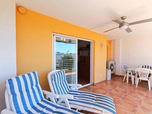a living room with two chairs and a table at Ayf luminoso en playa morro de gos in Oropesa del Mar
