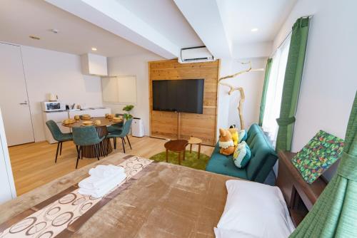 a living room with a bed and a dining room at feel Akihabara STAY in Tokyo