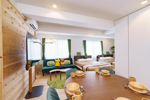 a living room with a bed and a dining room at feel Akihabara STAY in Tokyo