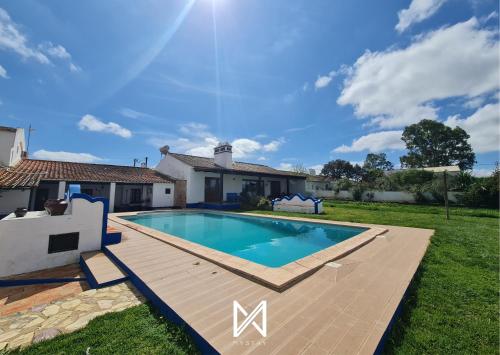 a swimming pool in the yard of a house at MyStay - Casa do Guizo in Mértola