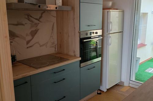 a kitchen with a stove and a refrigerator at Apartment with terraces in Rayol-Canadel-sur-Mer in Rayol-Canadel-sur-Mer