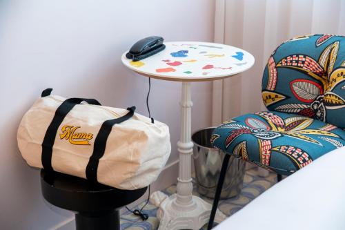 a bag sitting on a table next to a chair at Mama Shelter Lisboa in Lisbon