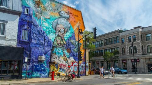 a mural on the side of a building on a street at Brand new 2 bedroom in the heart of the city in Montréal