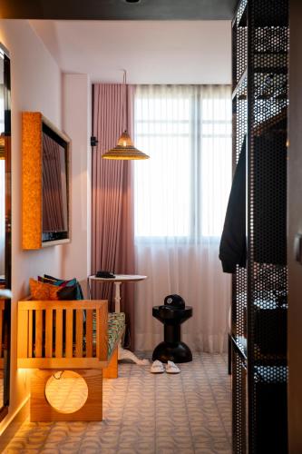 a living room with a crib and a window at Mama Shelter Lisboa in Lisbon