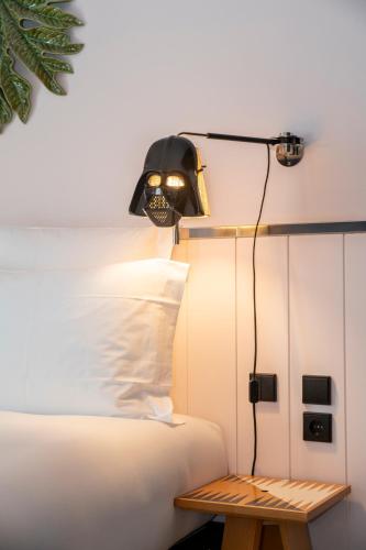 a lamp on the head of a bed at Mama Shelter Lisboa in Lisbon