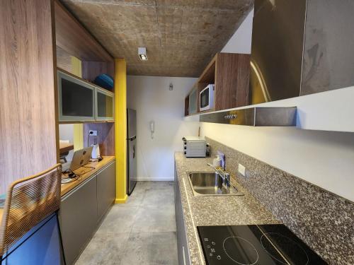 a kitchen with a sink and a counter top at Álamos de los Andes - Andarlibre in San Martín de los Andes