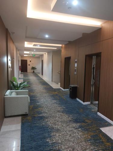 a hallway of an office building with a carpeted corridor at Doolv Serviced Apartments in Tabuk