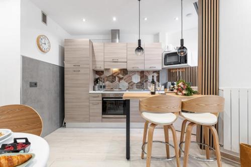 une cuisine avec une table et deux tabourets dans l'établissement SMOLETT - Superb Studio Suite Downtown w AC, à Nice