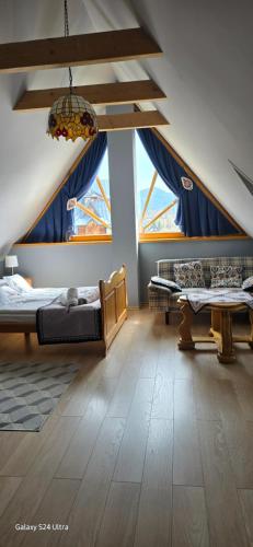 une chambre avec deux lits et deux fenêtres dans l'établissement Domek za Strugiem - pokoje i apartamenty, à Zakopane